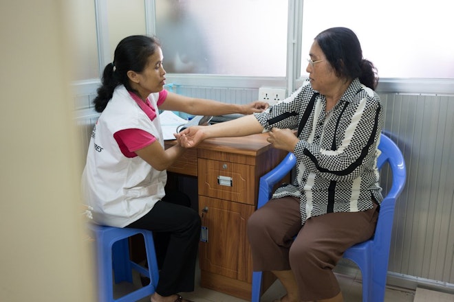 Verpleegkundige Van Sokha meet de bloeddruk van de 61-jarige patiënt Nov Sokah.